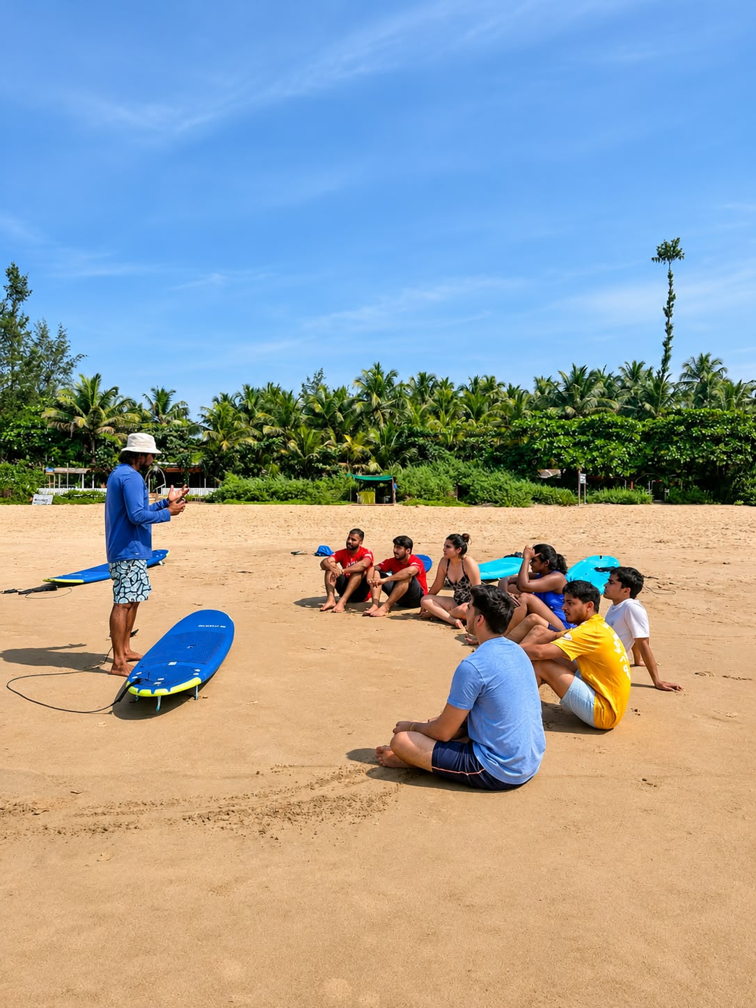Sandeep briefing a beginner surf class on the beach